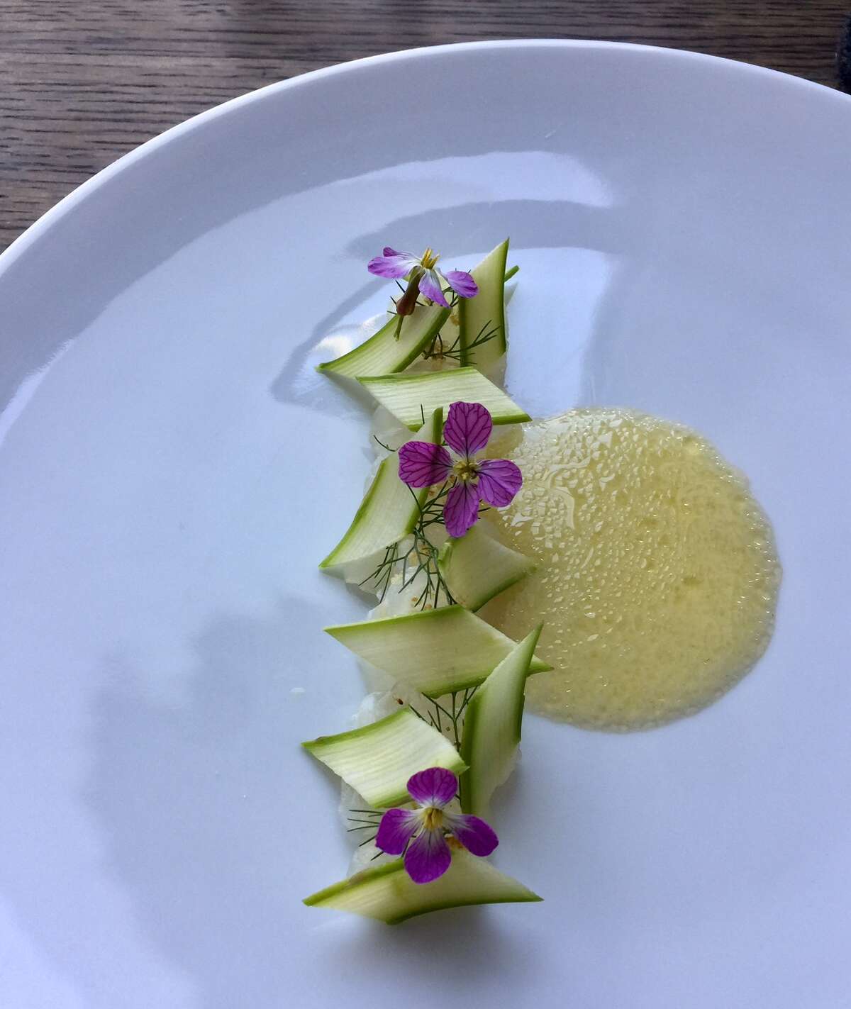 Commis, Oakland: One of the 12-courses on the $149 menu features salted spring flounder with bay laurel blossoms and elderflower vinegar and safflower
