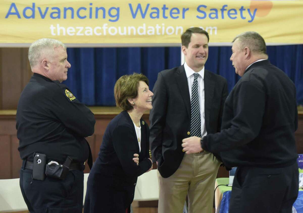 Greenwich Chief of Police James Heavey, left, State Rep. Livvy Floren, U.S. Rep. Jim Himes, second from right, and Greenwich Fire Chief Peter Siecienski chat before the ZAC Foundation swim camp closing ceremony at the Boys and Girls Club of Greenwich in Greenwich, Conn. Thursday, April 13, 2017. Children participated in the week-long ZAC Foundation swim camp at the Boys and Girls Club where they will spent time swimming in the pool while also learning important lessons about swimming safety. Karen and Brian Cohn founded The ZAC Foundation in 2008 in honor of their 6-year-old son, Zachary, who died after his arm became entrapped in a pool drain.