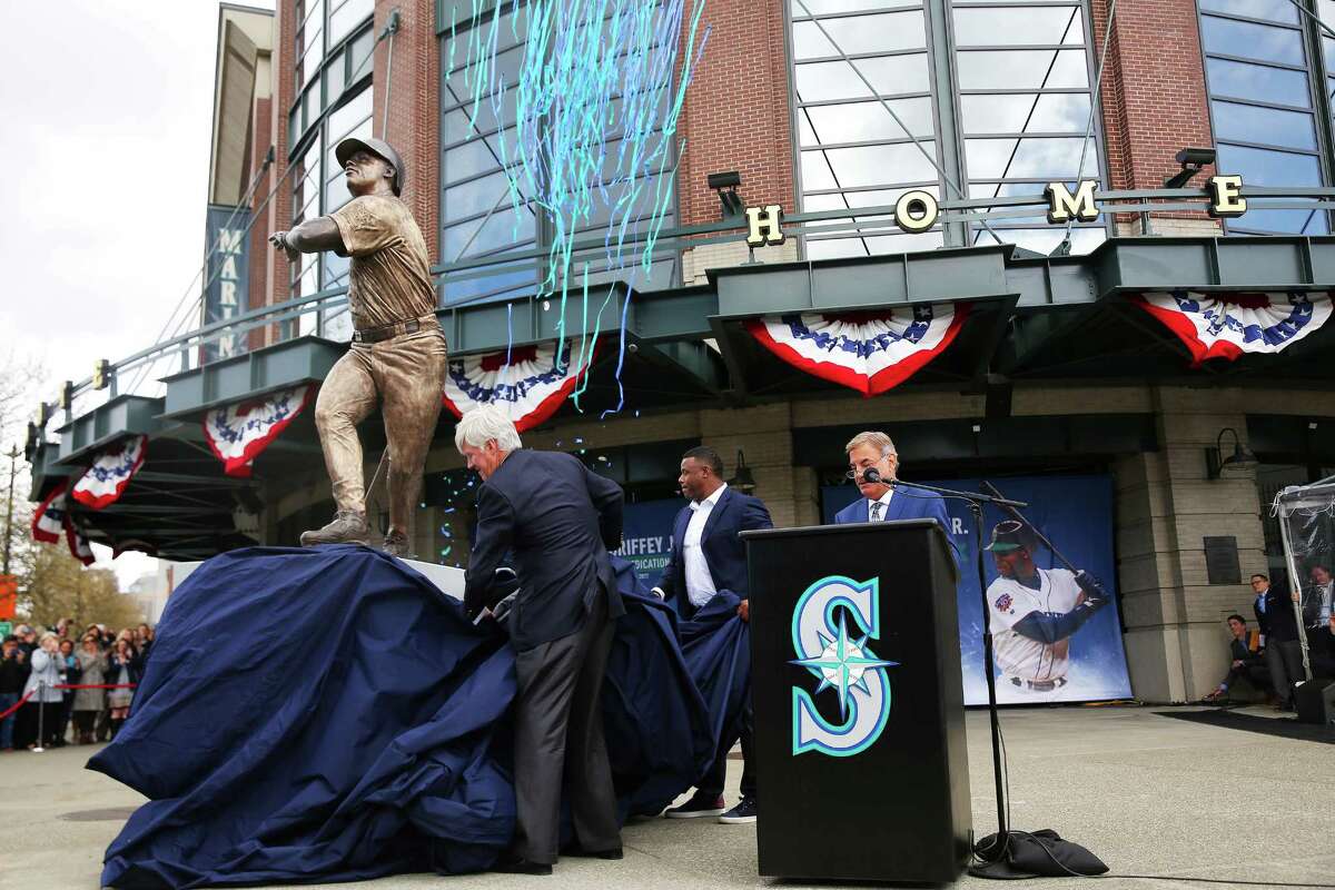 Former Mariner Ken Griffey Jr. and team owner John Stanton unveil a statue of the hall-of-famer outside Safeco Field, April 13, 2017. The statue was made by local artist Lou Cella.