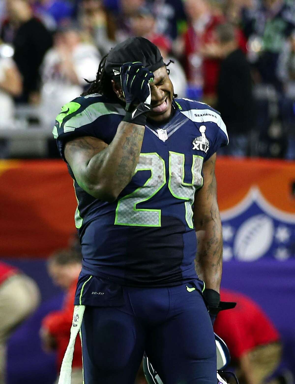 In this Sunday, Feb. 1, 2015, photo, Seattle Seahawks running back Marshawn Lynch reacts to the interception that sealed the Seahawks 28-24 loss to the New England Patriots in the NFL Super Bowl XLIX football game in Glendale, Ariz. (AP Photo/The Seattle Times, Bettina Hansen) SEATTLE OUT; USA TODAY OUT; MAGS OUT; TELEVISION OUT; NO SALES; MANDATORY CREDIT TO BOTH THE SEATTLE TIMES AND THE PHOTOGRAPHER