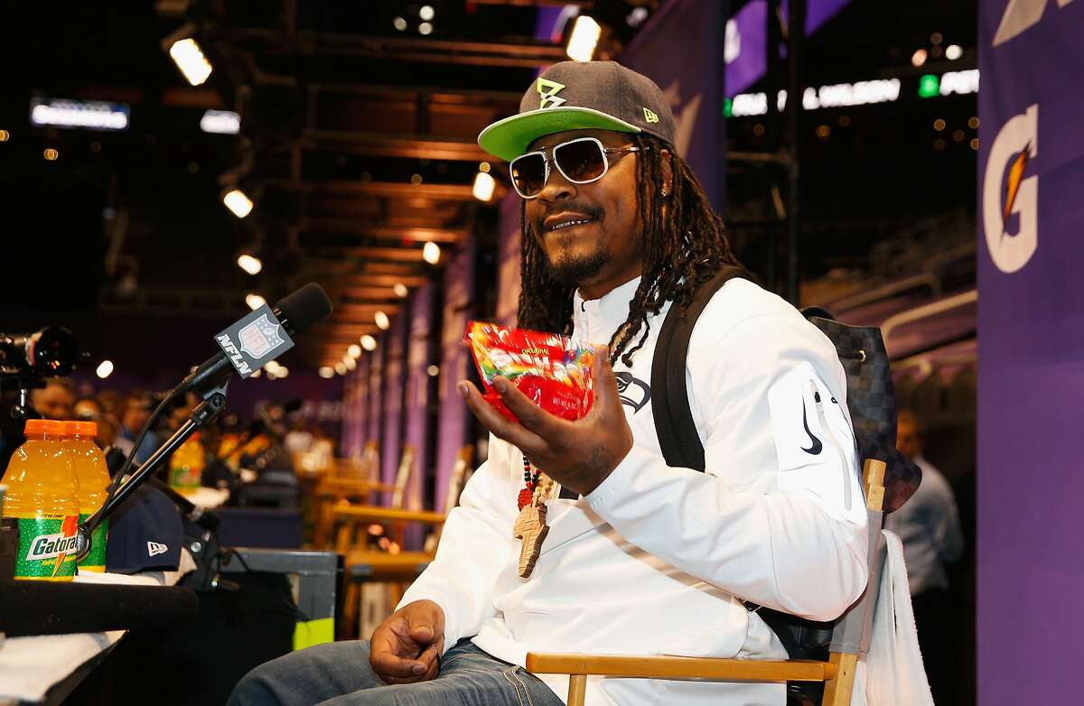 FILE -- Marshawn Lynch #24 of the Seattle Seahawks eats Skittles as he addresses the media at Super Bowl XLIX Media Day Fueled by Gatorade inside U.S. Airways Center on January 27, 2015 in Phoenix, Arizona.