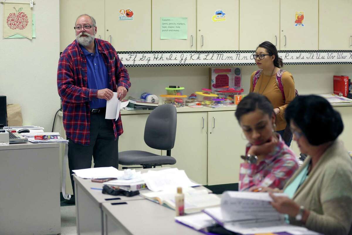 Raymond Elliott, left, talks to students Wednesday, April 12, 2017 during one of the education classes he teaches at St. Philips College. Using family money, Elliott has created a $500,000 scholarship endowment for St. Philip's students. It's the largest educator-funded endowment in Alamo Colleges history. He decided the endowment would be his legacy after he was told two days before Christmas that he would die soon without a lung transplant, although his prognosis has since improved (he has COPD.) He has taught for 21 years.