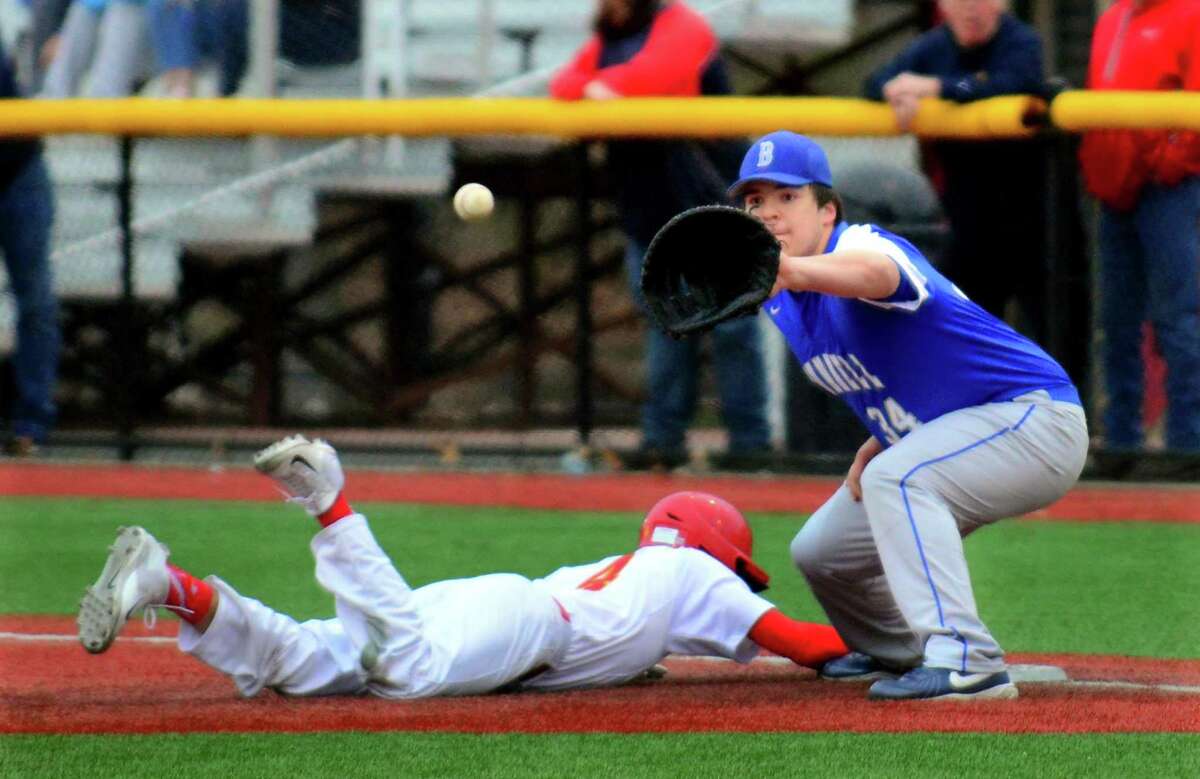 Stratford's Braydon Seaburg dives back to first to avoid being picked off by Bunnell's Michael Slimak-Vining during baseball action in Stratford, Conn. on Thursday Apr. 13, 2017.