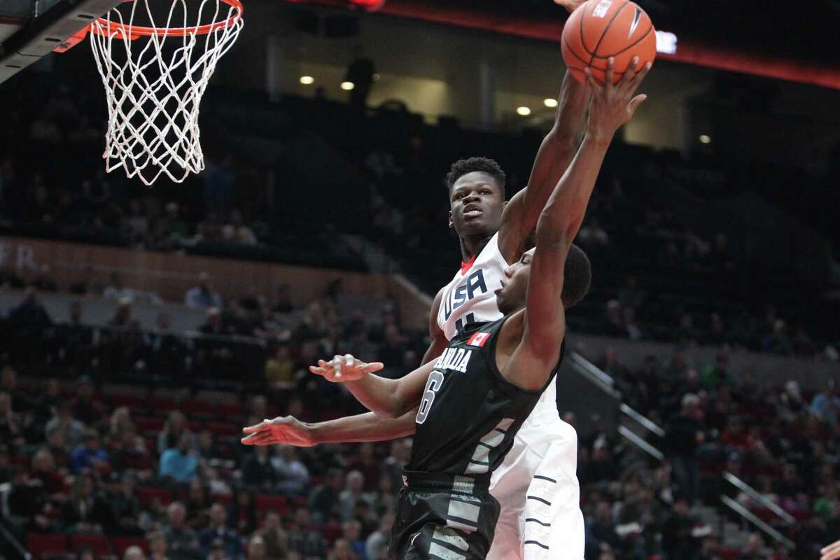 Team USA’s Mohamed Bamba blocks a shot by World Select Team’s R.J. Barrett during the Nike Hoop Summit basketball game in Portland, Ore., on April 7, 2017.
