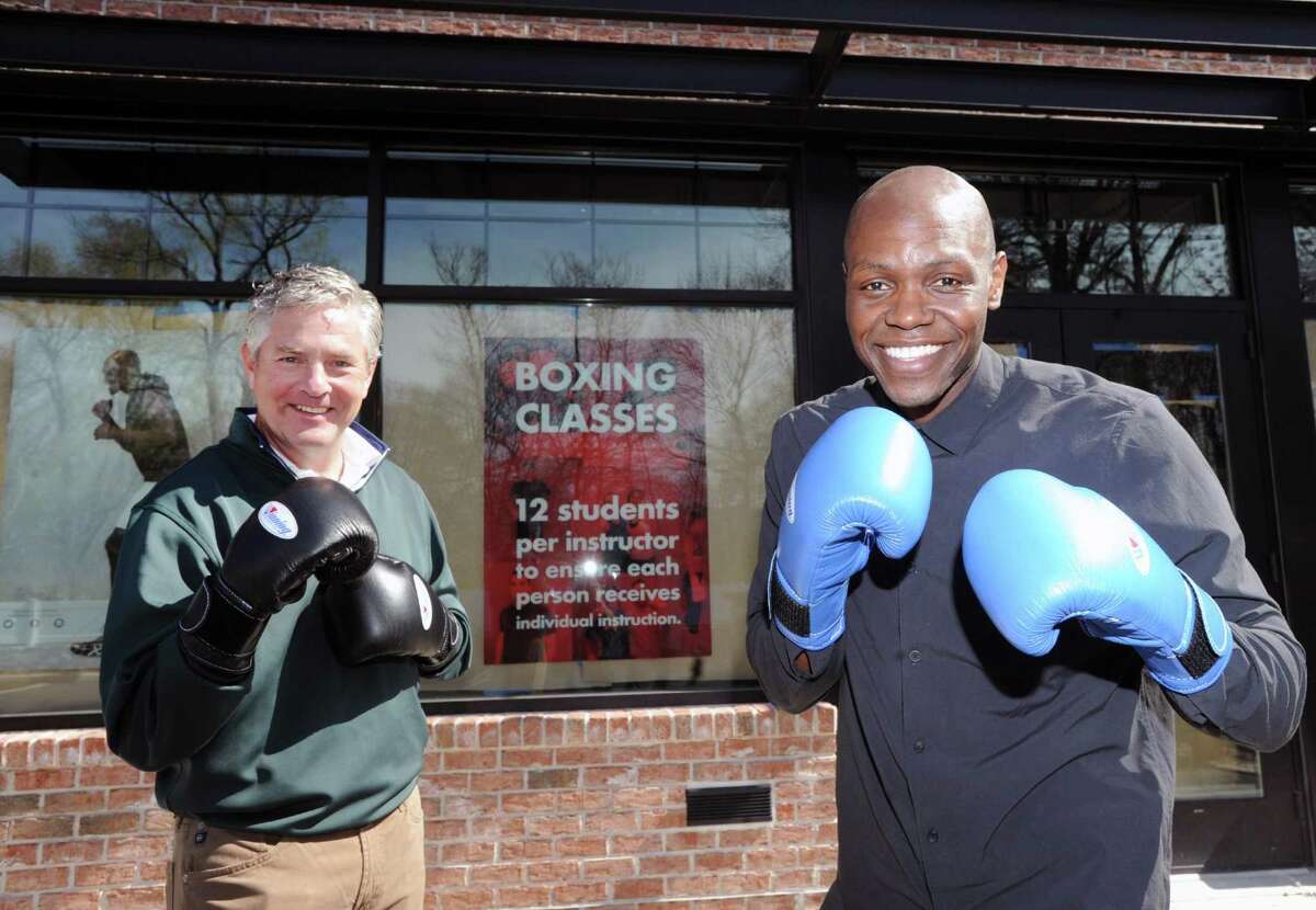 Jim Perry, left, and Jonathan Edmond, co-owners of Belly and Body, a new independent boxing gym, pose with boxing gloves at their gym that is under construction in Greenwich, Conn., Thursday, April 13, 2017. Perry and Edmond said their gym will be opening by the end of May.