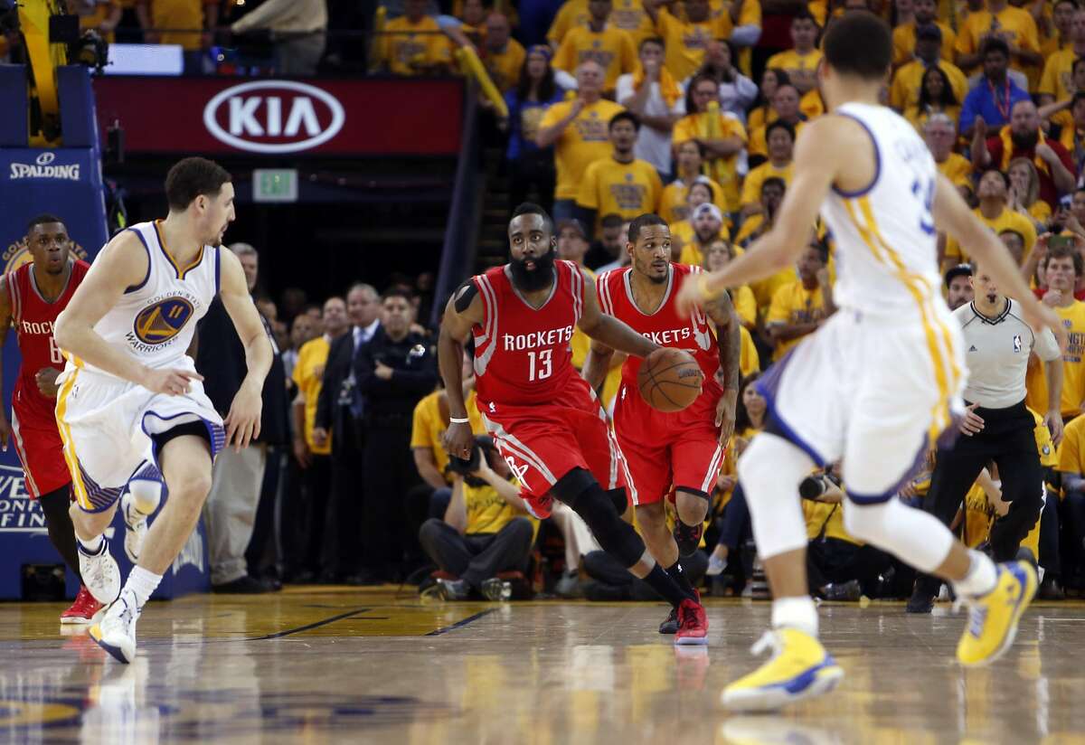 Houston Rockets' James Harden heads up court in final seconds of 4th quarter as Golden State Warriors' Klay Thompson and Stephen Curry transition to defense during 99-98 win in Game 2 of NBA Playoffs' Western Conference Finals at Oracle Arena in Oakland, Calif., on Thursday, May 21, 2015.