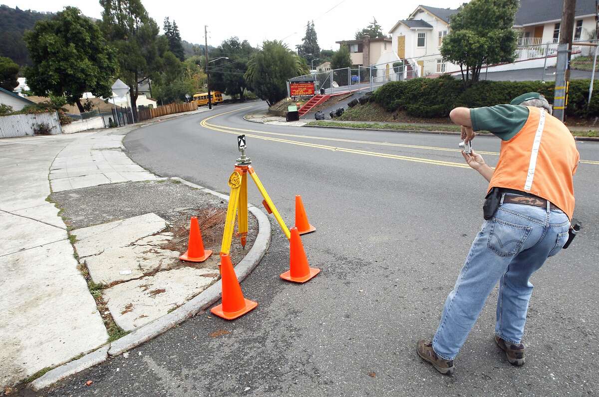 US Geological survey scientists James J. Lienkaemper records the placement of his equipment after measuring the "creep" along the Hayward Fault on Simpson Street in Oakland. Lienkaemper detected movement within a couple millimeters of last year?•s measurement. This year the measuring is very close to the Loma Prieta anniversary. Wednesday Oct 14, 2009