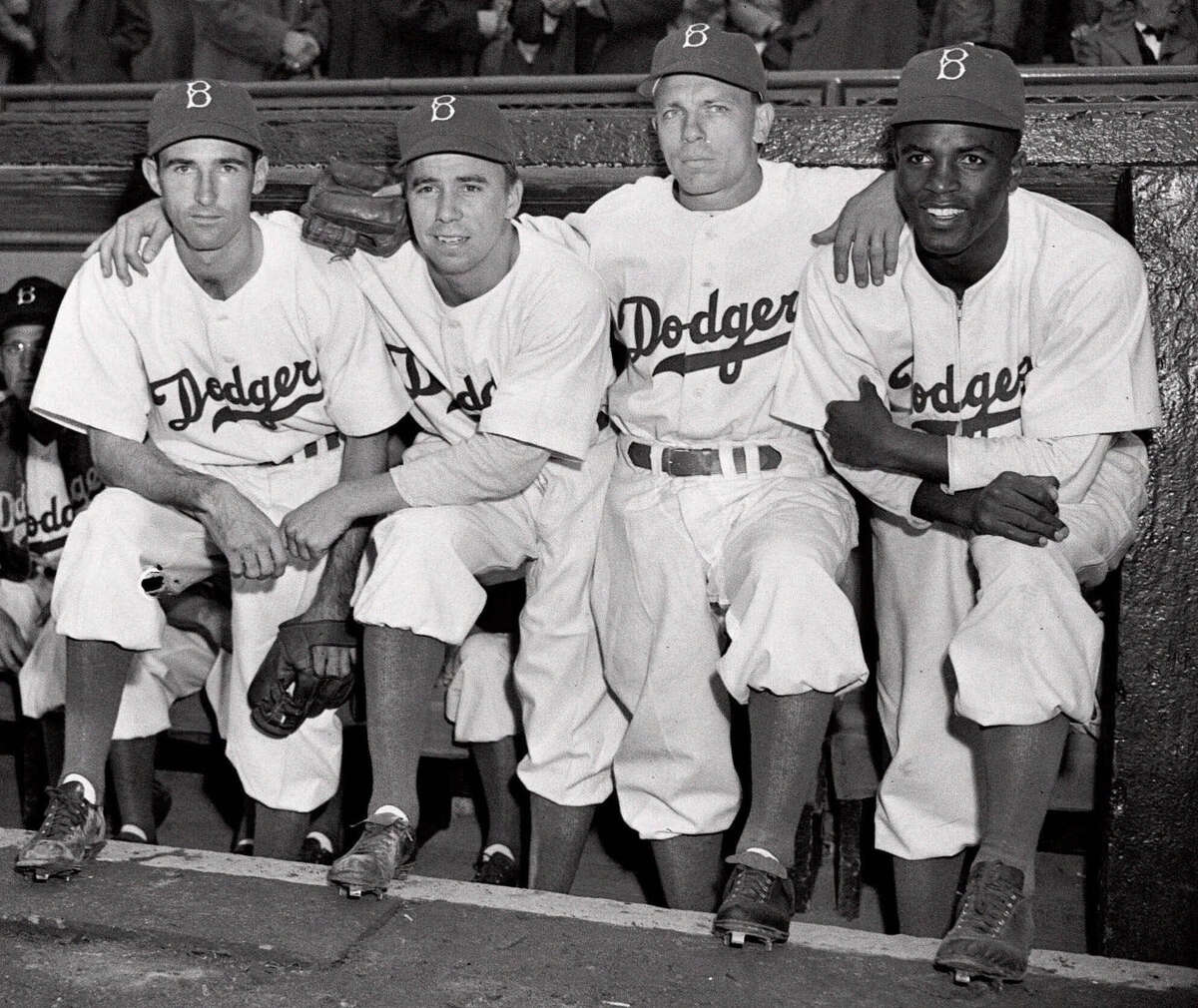 FILE - In this April 15, 1947, file photo, from left, Brooklyn Dodgers baseball players John Jorgensen, Pee Wee Reese, Ed Stanky and Jackie Robinson pose at Ebbets Field in New York. The first statue in Dodger Stadium history belongs to Jackie Robinson. The team will unveil his likeness during Jackie Robinson Day festivities on Saturday, April 15, 2017, with his wife and extended family in attendance on the 70th anniversary of him breaking baseball's color barrier (AP Photo, File)