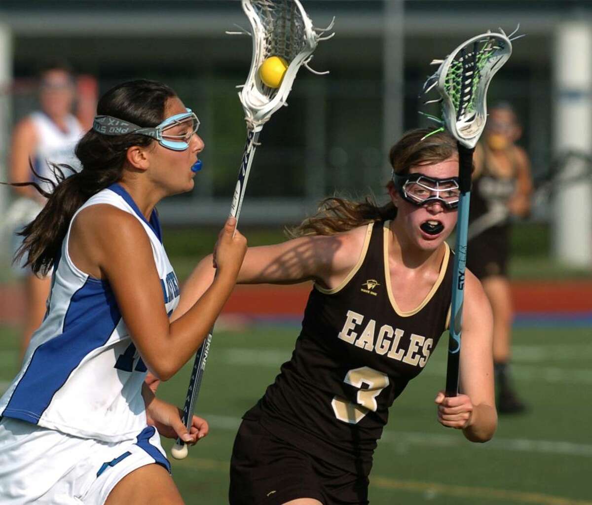 Fairfield Ludlowe's #13 Stephanie Gorab, left, carries the ball as Trumbull's #3 Keri Mahoney looks to intercept, during CIAC first round lacrosse action in Fairfield, Conn. on Thursday June 03, 2010.