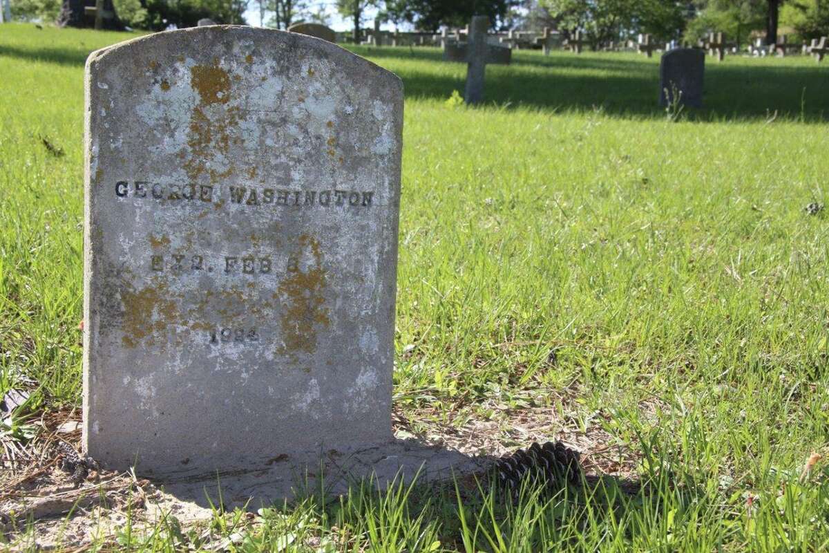 This April 5, 2017 photo shows the tombstone of Texas prisoner George Washington at the Texas prison cemetery in Huntsville, Texas. Washington was one of five convicts put to death on Feb. 8, 1924, the first time Texas used the electric chair for capital punishment. It was one of 28 times the electric chair in Texas was used more than once in a single night. Arkansas is set to use a three-drug mixture for a scheduled eight lethal injections, two each on four days, starting Monday. (AP Photo/Michael Graczyk)