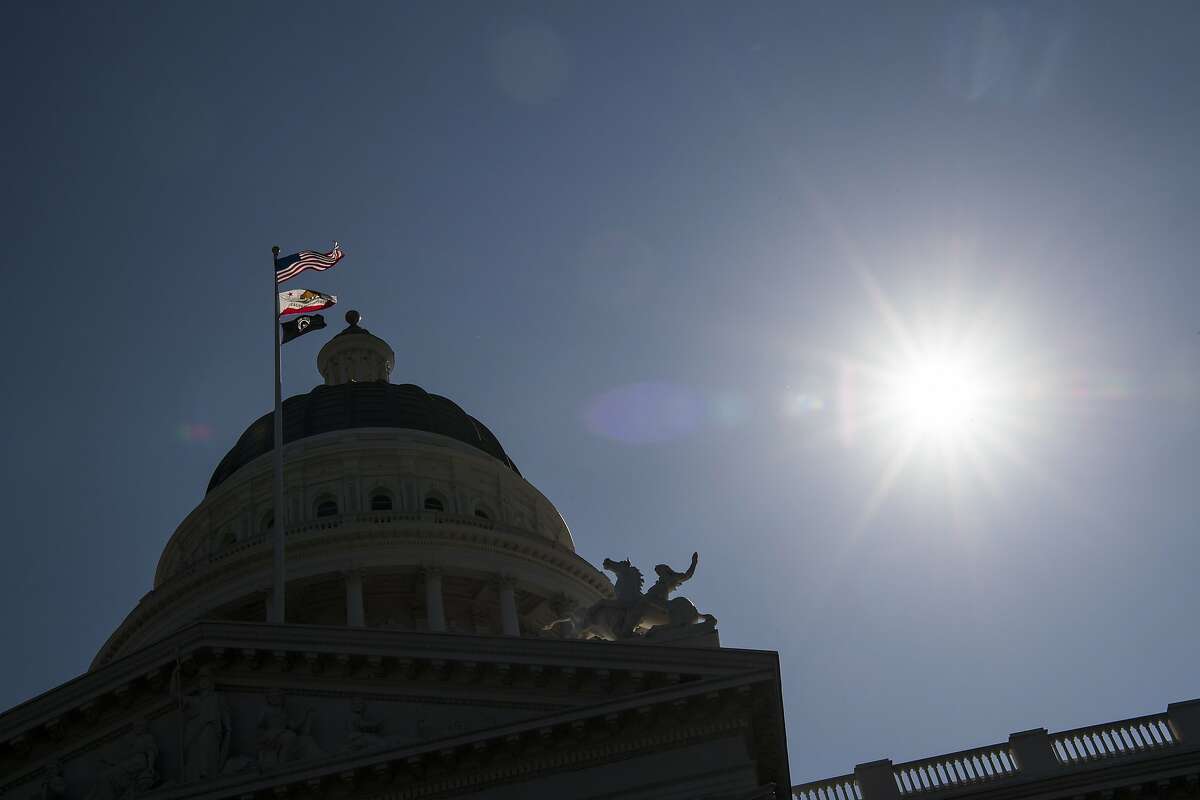 The American, California State, and POW/MIA flags fly in front of the California State Capitol building in Sacramento, California, U.S., on Thursday, March 30, 2017. California Governor Jerry Brown and legislative leaders proposed a plan to raise taxes and levy new fees to pay the bulk of $52.4 billion in transportation projects over 10 years. Photographer: David Paul Morris/Bloomberg