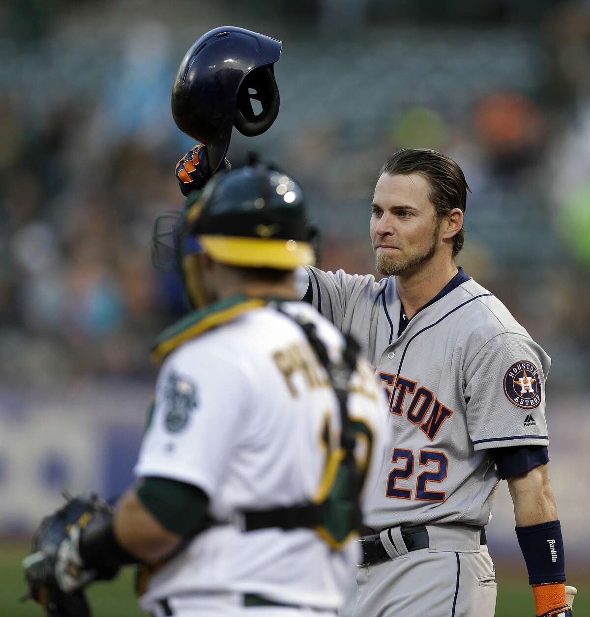 Houston Astros' Josh Reddick (22) tips his helmet to fans as he comes to bat against the Oakland Athletics in the first inning of a baseball game Friday, April 14, 2017, in Oakland, Calif. This is Reddick's first return to Oakland since July 2016, when he was a right fielder for the Athletics. (AP Photo/Ben Margot)