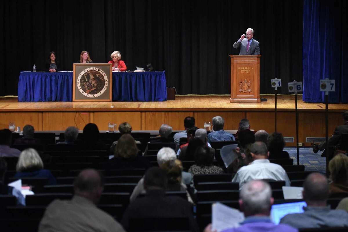 Moderator Thomas Byrne, right, speaks during the Representative Town Meeting at Central Middle School in Greenwich.