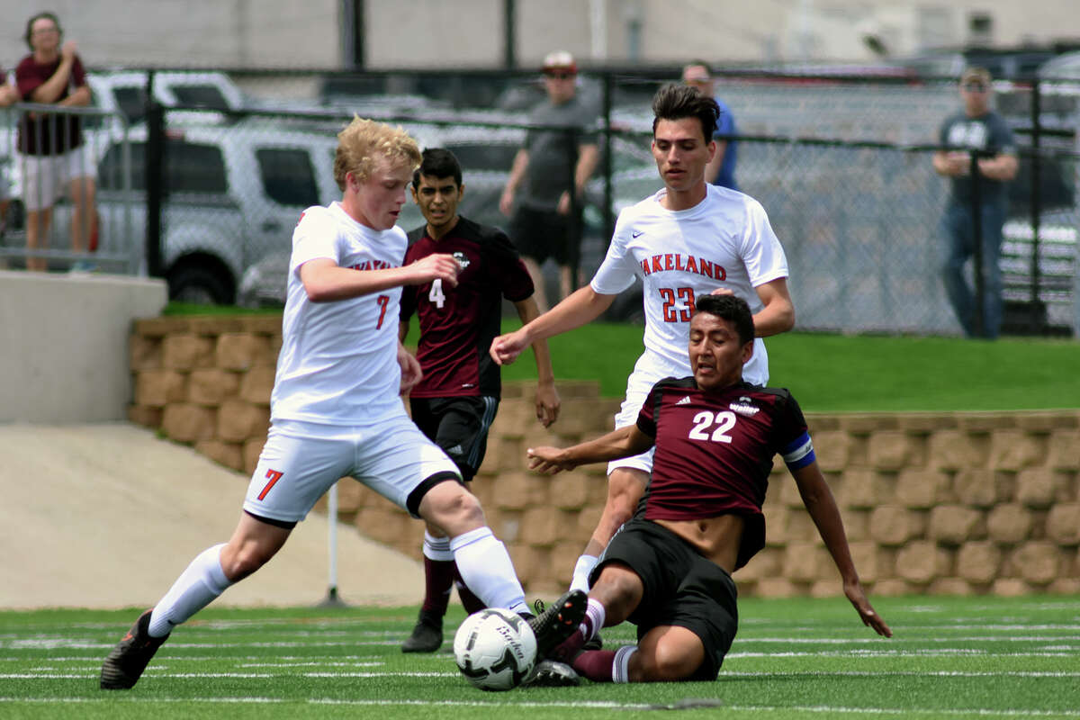 Waller senior midfielder Ricardo Lopez (22) slides for a possession against Frisco Wakeland freshman forward Todd Fuller (7) during the first period of their Class 5A Boys final matchup at the 2017 UIL Soccer State Championships at Birkelbach Field in Georgetown on Saturday, April 15, 2017. (Photo by Jerry Baker/Freelance)