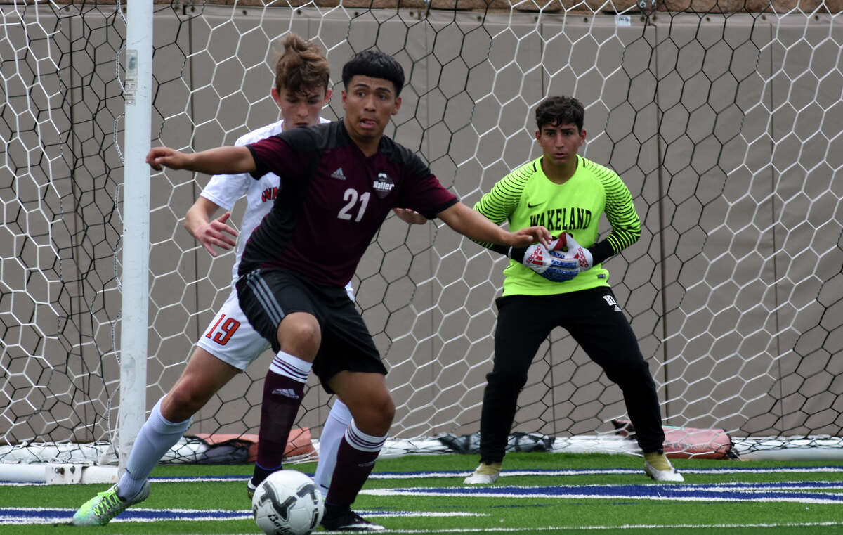 Waller senior forward Luis Garcia (21) works for a pass in front of the Frisco Wakeland goal and Wolverine defender Adam Stalmach (19) and goalkeeper Noah Samadian (99) during the first period of their Class 5A Boys final matchup at the 2017 UIL Soccer State Championships at Birkelbach Field in Georgetown on Saturday, April 15, 2017. (Photo by Jerry Baker/Freelance)