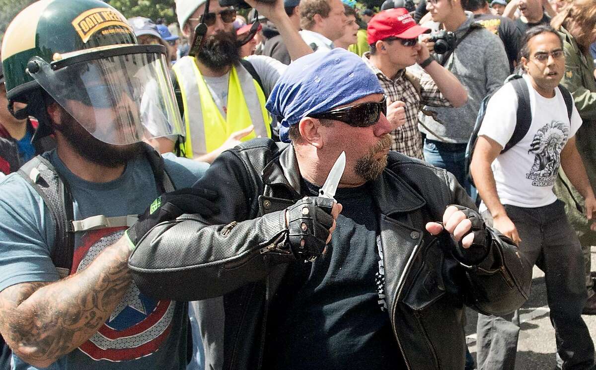 A demonstrator supporting President Donald Trump wields a knife during a fight with counter-protesters on Saturday, April 15, 2017, in Berkeley, Calf.