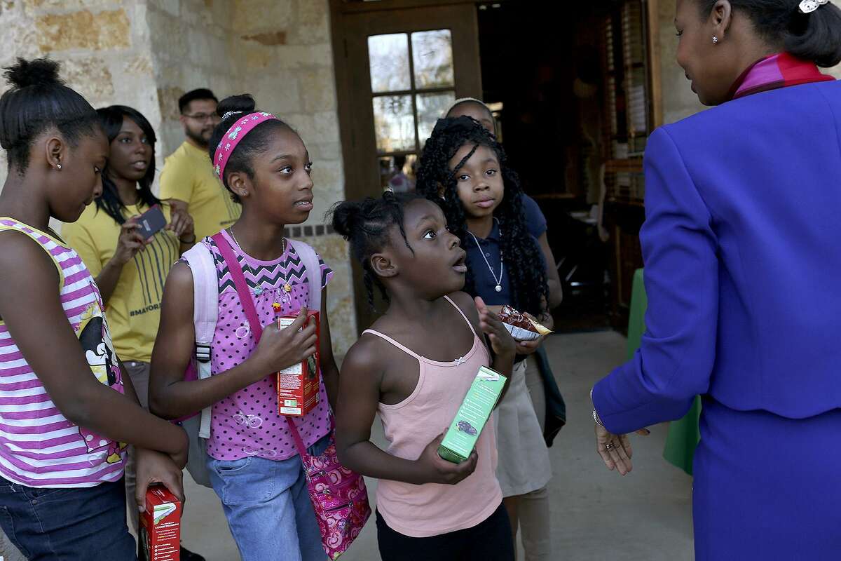 Mayor Ivy Taylor greets a group of Girl Scouts selling cookies as she arrives for a mayoral forum held by Alamo Community Group at the Meadows at Bentley Drive apartments on February 22, 2017.
