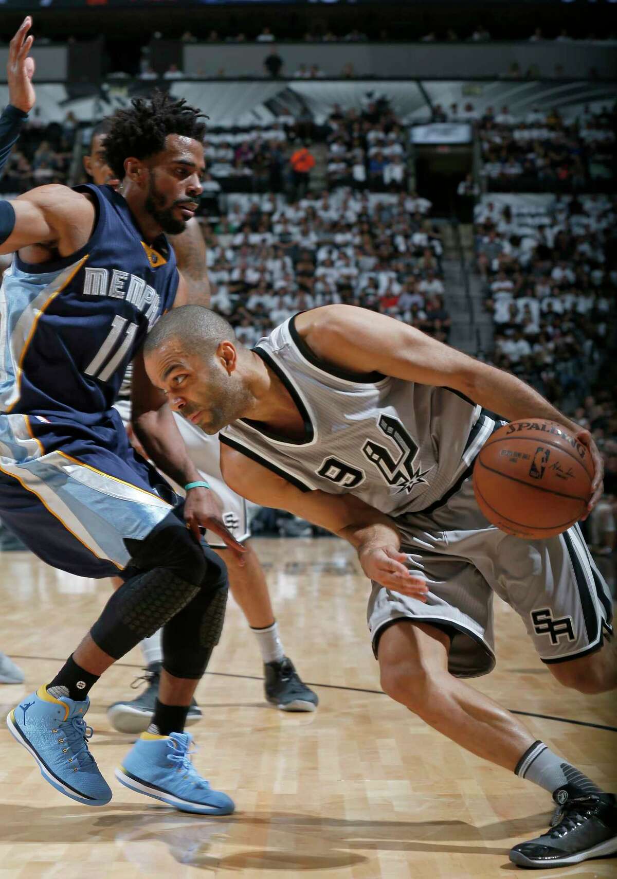 San Antonio Spurs' Tony Parker looks for room around Memphis Grizzlies?• Mike Conley during first half action of Game 1 in the first round of the Western Conference playoffs held Saturday April 15, 2017 at the AT&T Center.
