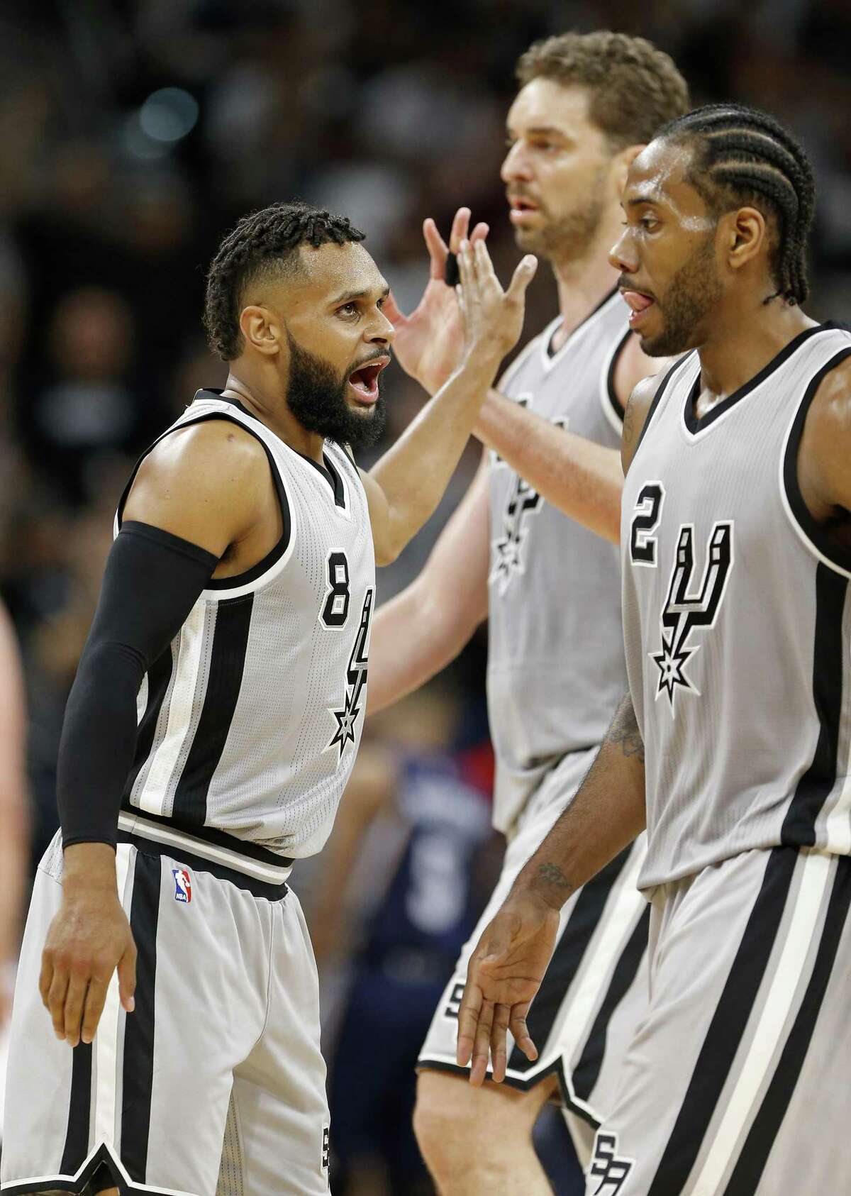 San Antonio Spurs' Patty Mills celebrates with teammates Pau Gasol, and Kawhi Leonard after making a 3-pointer during second half action of Game 1 in the first round of the Western Conference playoffs against the Memphis Grizzlies Saturday April 15, 2017 at the AT&T Center. The Spurs won 111-82.