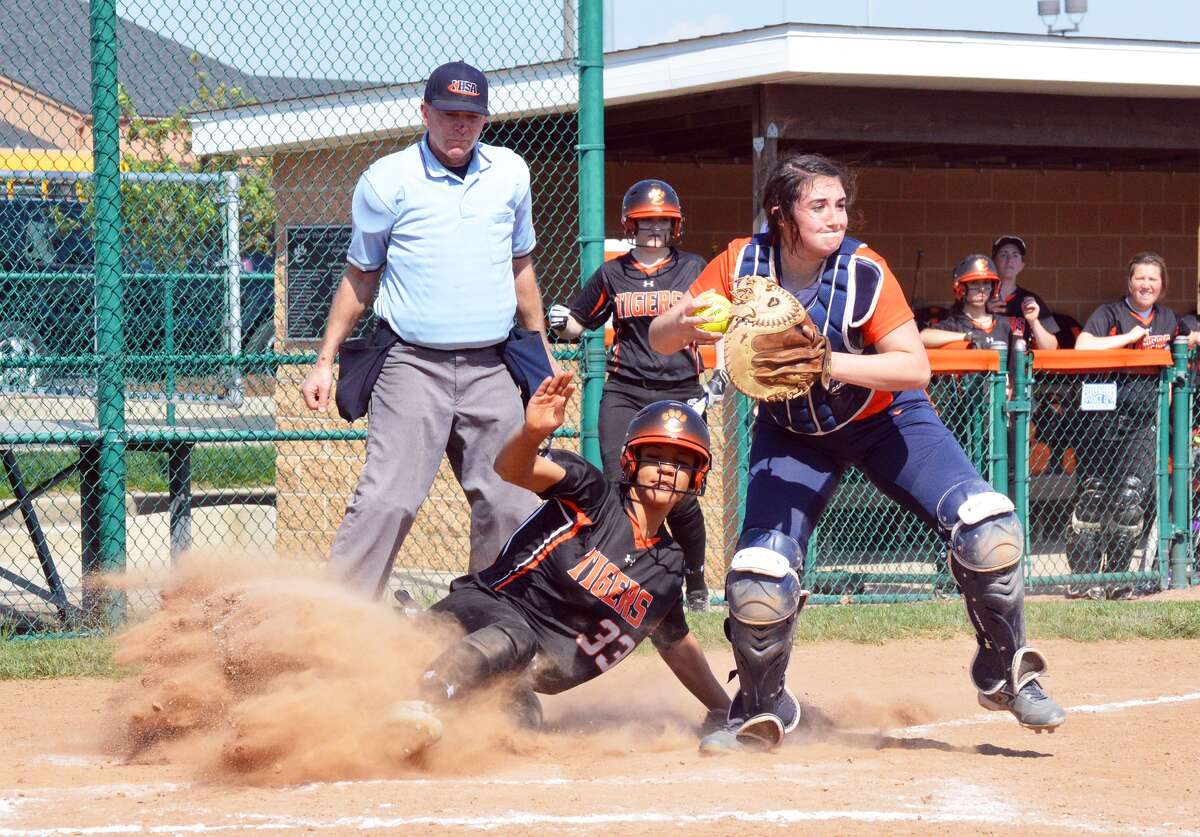 Edwardsville’s Maria Smith slides into home plate during the first game of a doubleheader against Rochester on Saturday inside the District 7 Sports Complex.