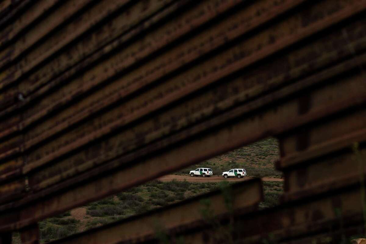(FILES) This file photo taken on February 14, 2017 shows US Border Patrol vehicles seen through the US/Mexico border fence in Tecate, northwestern Mexico. With debate raging in the United States and Mexico over President Donald Trumps plan to build a wall along the nations border, AFP photographers decided to take a closer look. So they drove the drove the nearly 1,750 miles along the border and photographed what they saw, with Washington-based Jim Watson on the US side and Tijuana-based Guillermo Arias and Mexico City-based Yuri Cortez on the Mexican side. / AFP PHOTO / GUILLERMO ARIASGUILLERMO ARIAS/AFP/Getty Images