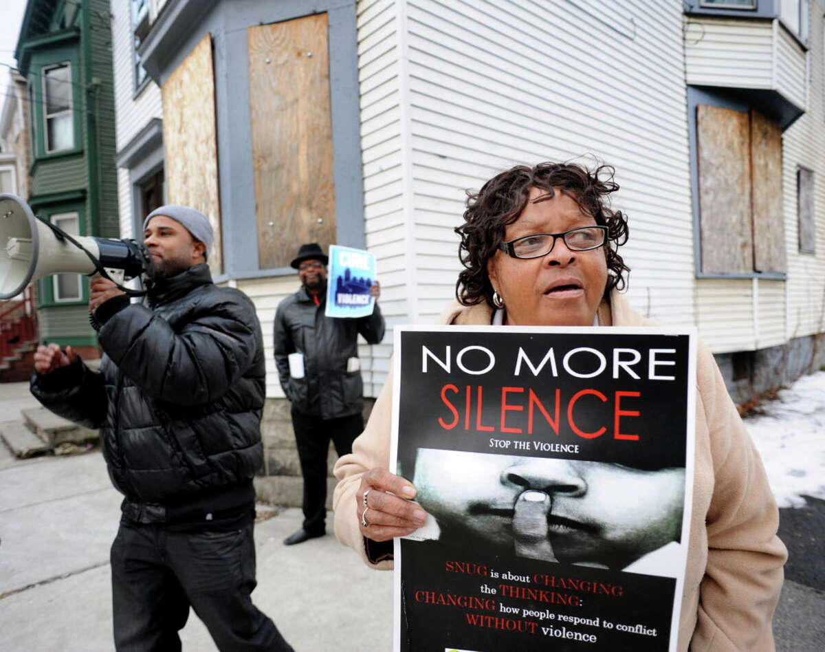 Beverly Padgett, chair of the Albany Community Policing Advising Committee, right, lends her voice to a Cure Violence, formerly SNUG, rally at the corner of North Lake Avenue and Second Street on Thursday, March 20, 2014, in Albany, N.Y. Joining her are program director Clarence Jackson, left, and community advocate Marlon Anderson. (Cindy Schultz / Times Union)