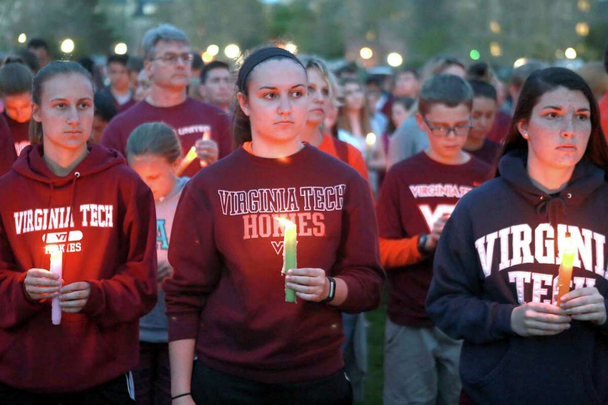 People participate in a candle light vigil Sunday, April 16, 2017, in Blacksburg Va., as part of the closing ceremony marking the 10th anniversary of the deadly shooting at Virginia Polytechnic Institute and State University, widely known as Virginia Tech, on April 16, 2007. (Matt Gentry/The Roanoke Times via AP) ORG XMIT: VAROA212