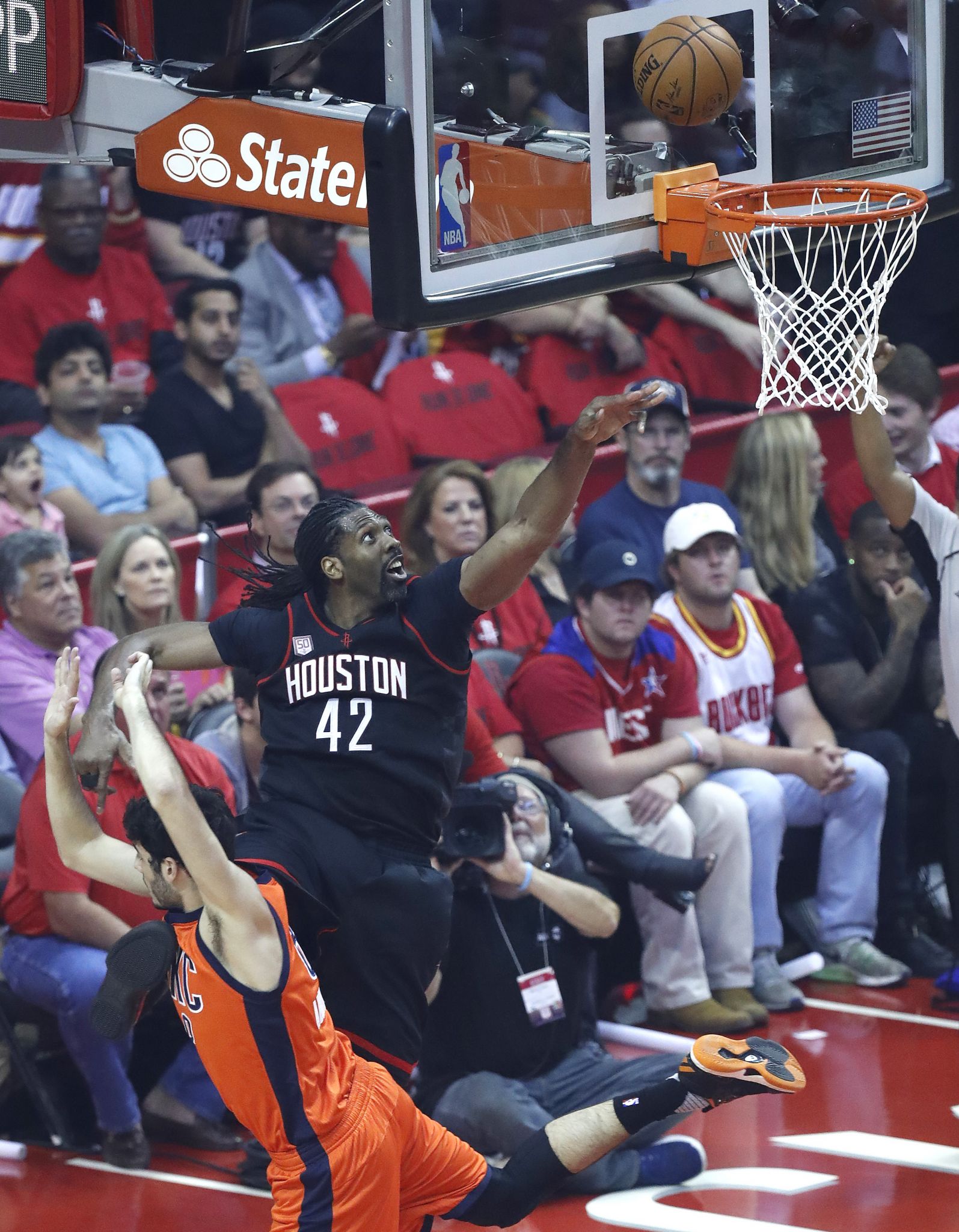 Houston Rockets' James Harden acknowledges the crowd after stealing the  ball and taking it to the basket for a dunk during the first half in Game 4  of a first-round NBA basketball