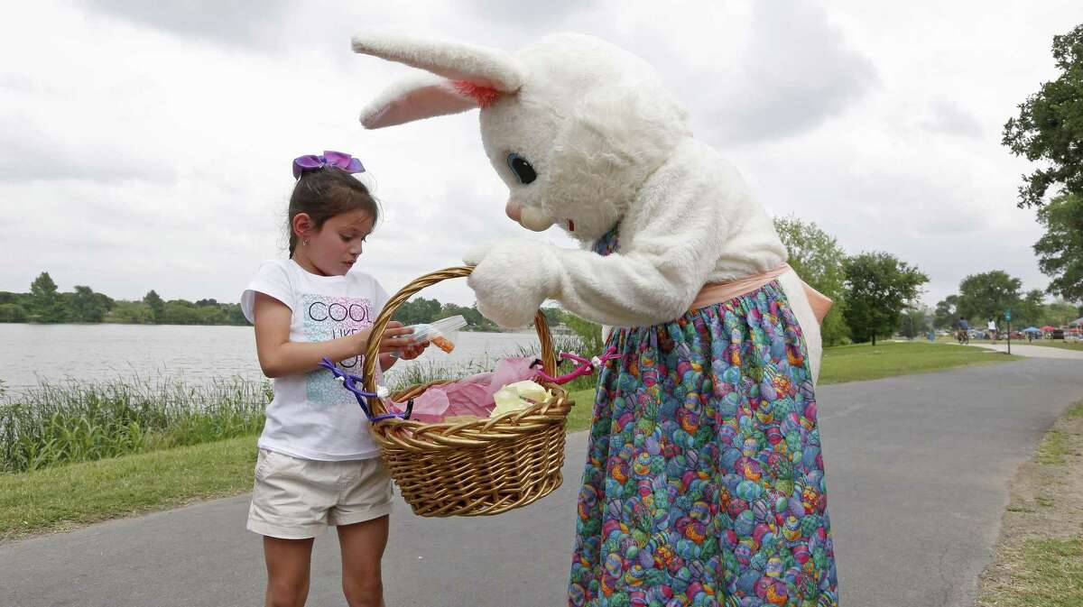Nyshya Lopez, 6, receives candy from Virginia Salinas, 57, as the Easter Bunny, while enjoying Easter with her family at Woodlawn Lake Park last Sunday. A reader praises a recent column on the blessings of Easter — and life.