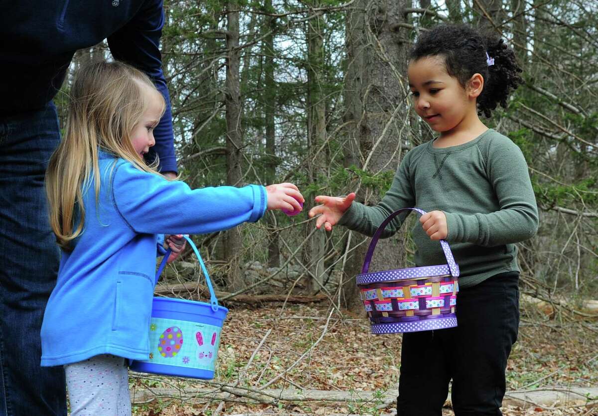Kayleigh Stein, 2, of Fairfield, left, shares one of her Easter eggs with her new friend Amarissa McKenzie-Mastroianni, 4, also from Fairfield, during the Audubon Society Center at Fairfield's "Egg Hunt Egg-Stravaganza" event in Fairfield, Conn., on Saturday Apr. 15, 2017. As many as 500 people came out to take part in the hunt, which took visitors along the scenic trails behind the center. Volunteers from the National Charity League's Easton and Fairfield Chapters came to help stuff the Easter eggs with surprises and crafts were held inside along with a visit from the Easter Bunny himself.