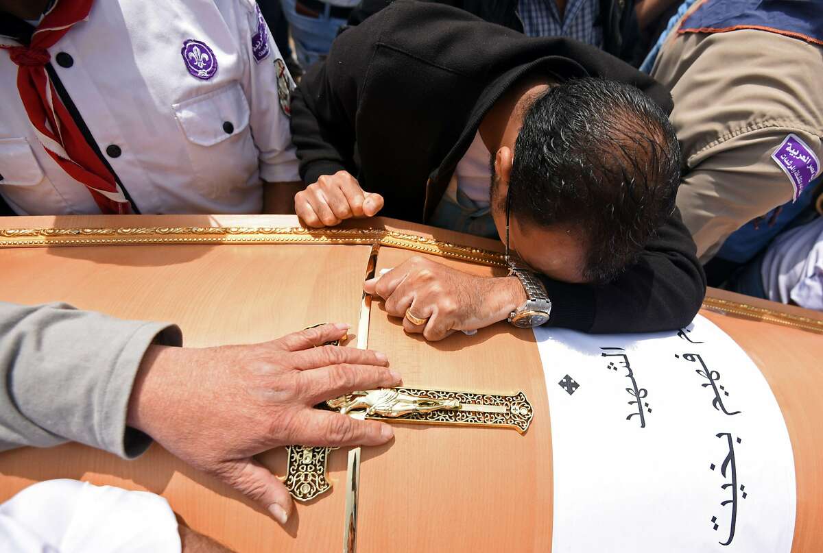 Men mourn over the coffin of one of the victims of the blast at the Coptic Christian Saint Mark's church in Alexandria the previous day during a funeral procession at the Monastery of Marmina in the city of Borg El-Arab, east of Alexandria, on April 10, 2017. Egypt prepared to impose a state of emergency after jihadist bombings killed dozens at two churches in the deadliest attacks in recent memory on the country's Coptic Christian minority. / AFP PHOTO / MOHAMED EL-SHAHEDMOHAMED EL-SHAHED/AFP/Getty Images