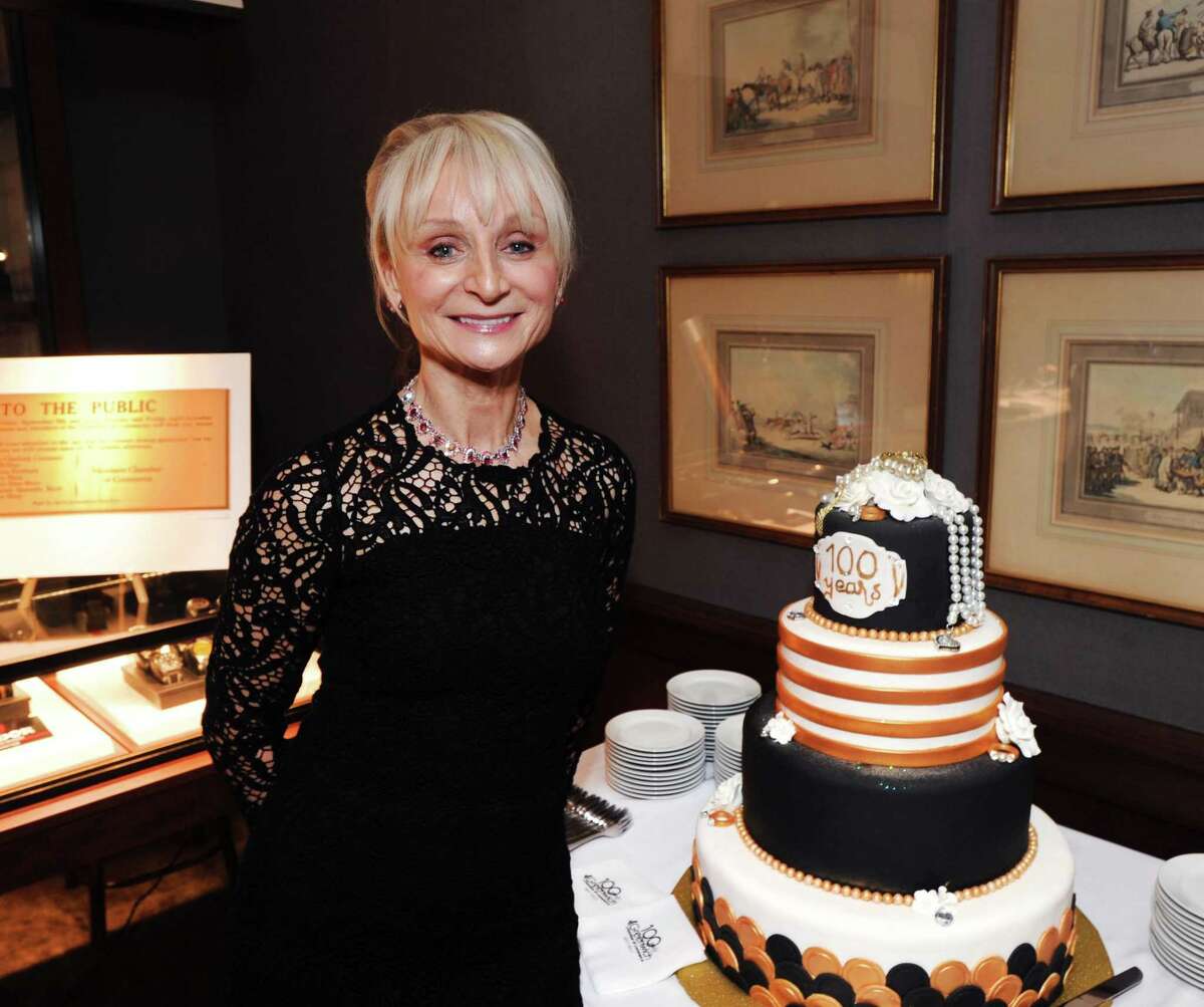 Marcia O'Kane, the president and chief executive officer of the Greenwich Chamber of Commerce with the birthday cake (provided by the Edgehill Retirement Community) during the chamber's Centennial Cocktail Celebration at Betteridge Jewelers located at 239 Greenwich Ave., Conn., Thursday, Jan. 26, 2017. The chamber was established in 1917 and the cocktail celebration was the first event among others to celebrate its 100th birthday. According to the organization's website, the stated purpose of the chamber is to improve the well-being of the entire business community while maintaining the residential integrity of the town.