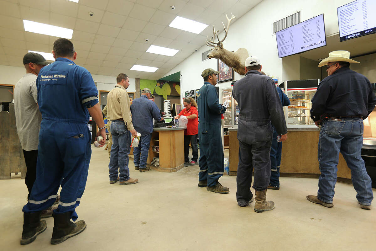 Oilfield workers crowd the counters at Wheeler's Mercantile in Tilden, Texas, Wednesday, April 2, 2014. The county seat of McMullen, County, Tilden is situated at the intersection of State Highway 72 and 16 in the heart of the Eagle Ford Shale play.