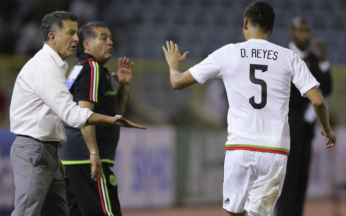 Mexico's Diego Reyes (5) celebrates with coach Juan Carlos Osorio after scoring his team's first goal against Trinidad and Tobago in a 2018 World Cup qualifying soccer match in Port of Spain, Trinidad and Tobago, Tuesday, March 28, 2017.(AP Photo/Fernando Llano)