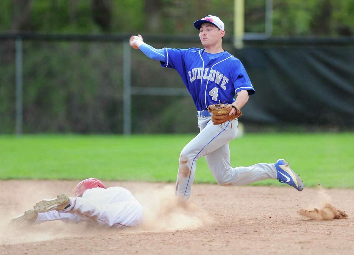Fairfield Ludlowe's Ryan Devaney attempts to turn a double play as Greenwich baserunner Brandon Chow slides safely into second base in Greenwich's 8-1 win over Fairfield Ludlowe in the high school baseball game at Greenwich High School in Greenwich, Conn. Monday, April 17, 2017.