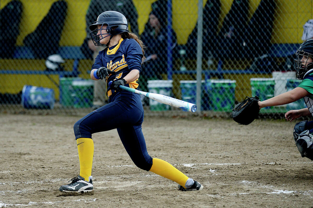 NICK KING | nking@mdn.net Midland's Julia Gross gets a hit against Heritage during the third inning on Monday at Midland High School. The Chemics won the first game of the double-header 10-0 in five innings.