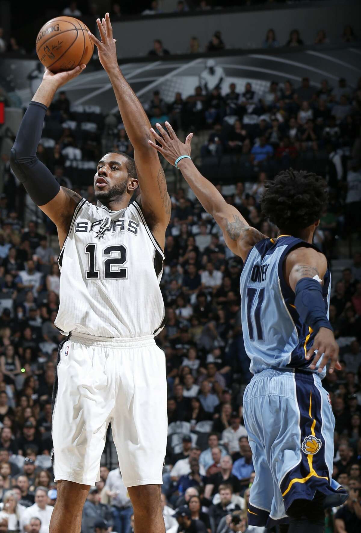 San Antonio Spurs' LaMarcus Aldridge shoots around Memphis Grizzlies?• Mike Conley during first half action of Game 2 in the first round of the Western Conference playoffs held Monday April 17, 2017 at the AT&T Center.
