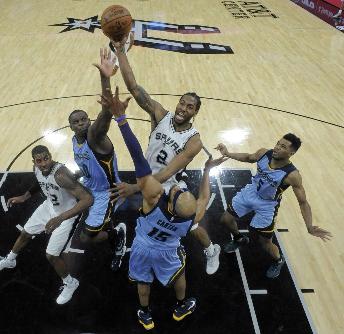 San Antonio Spurs' Kawhi Leonard shoots over Memphis Grizzlies?• Zach Randolph and Vince Carter during second half action of Game 2 in the first round of the Western Conference playoffs held Monday April 17, 2017 at the AT&T Center. The Spurs won 96-82.