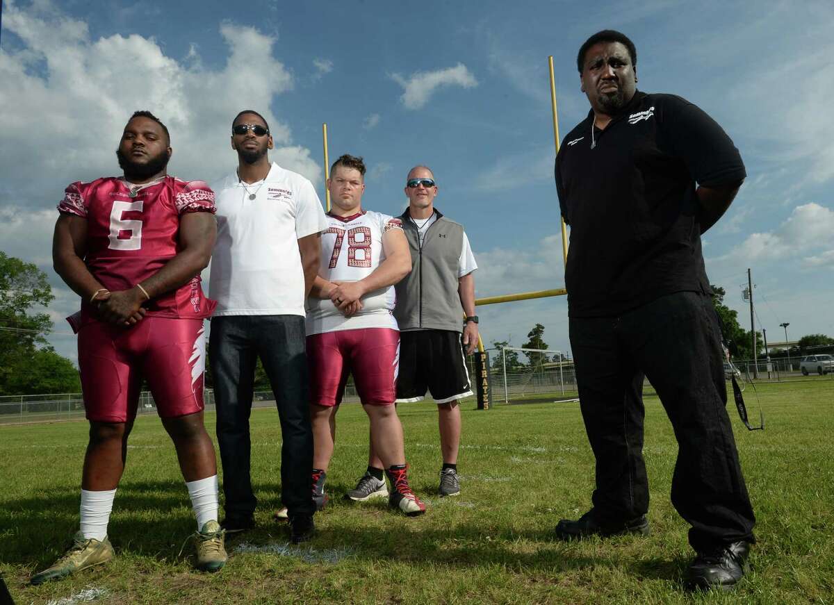 Wilford Scypion Jr., right, owner of the Golden Triangle Seminoles stands with, from left, Joe Lee, Russell Dycus, Justin Rideau, and Vidor football Coach Jeff Mathews, at the Vidor Junior High on Thursday. Photo taken Thursday, April 13, 2017 Guiseppe Barranco/The Enterprise