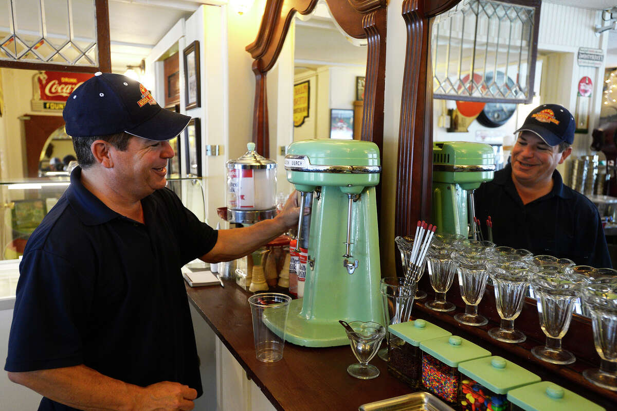 Mike Lisotta makes a milkshake with his vintage 1940s mixer at Mike's Old Fashioned Soda Fountain in downtown Port Neches on Friday. The city's small downtown area has seen an influx of new businesses trying to revitalize it over the past five years. Photo taken Friday 4/14/17 Ryan Pelham/The Enterprise
