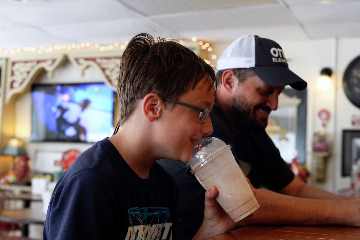 Tristan Alexander, 11, drinks a milkshake at Mike's Old Fashioned Soda Fountain in downtown Port Neches on Friday. The city's small downtown area has seen an influx of new businesses trying to revitalize it over the past five years. Photo taken Friday 4/14/17 Ryan Pelham/The Enterprise