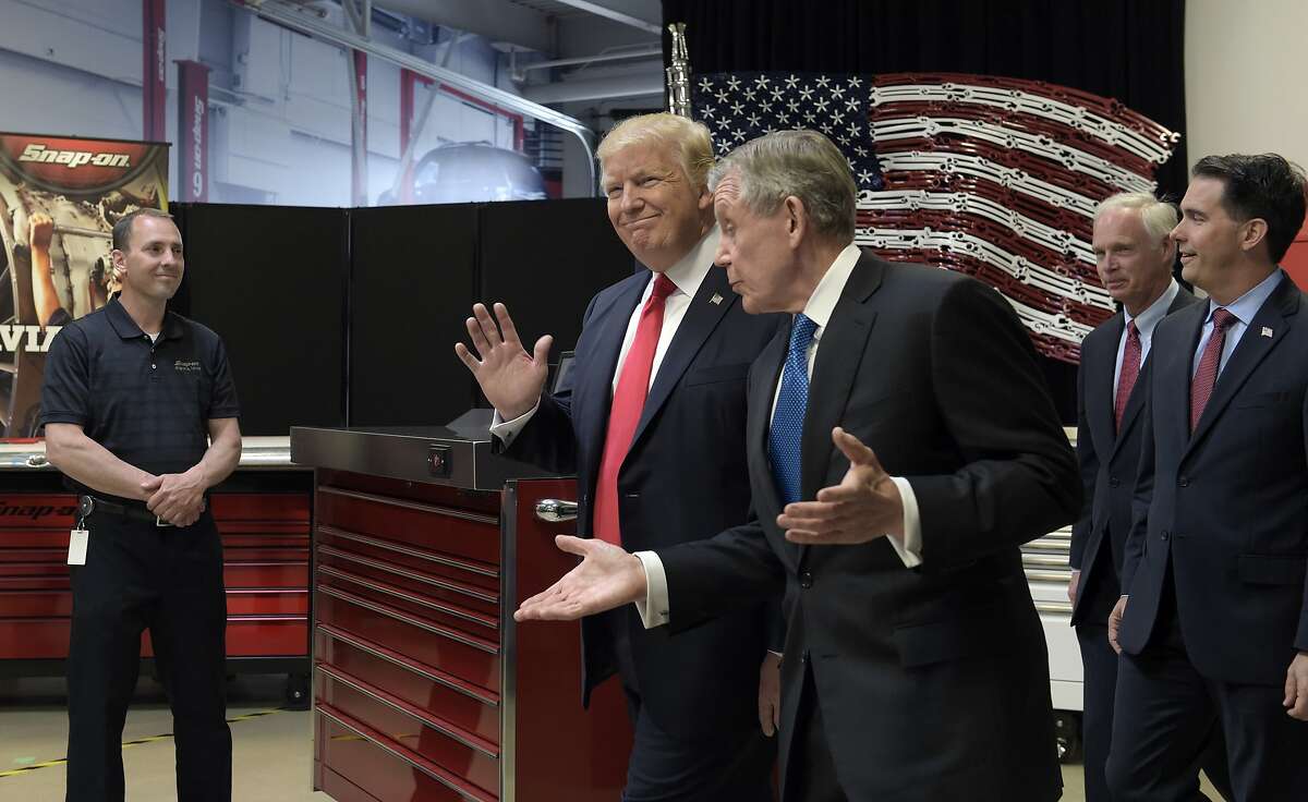 President Donald Trump tours the headquarters of tool manufacturer Snap-on Inc., with Chief Executive Officer Nicholas T. Pinchuk, center, followed by Sen. Ron Johnson, R-Wis., second from right, and Wisconsin Gov. Scott Walker, right, in Kenosha, Wis., Tuesday, April 18, 2017. Trump visited the headquarters of tool manufacturer Snap-on Inc., and will later sign a an executive order that seeks to make changes to a visa program that brings in high-skilled workers. Wisconsin Gov. Scott Walker follows at right.(AP Photo/Susan Walsh)