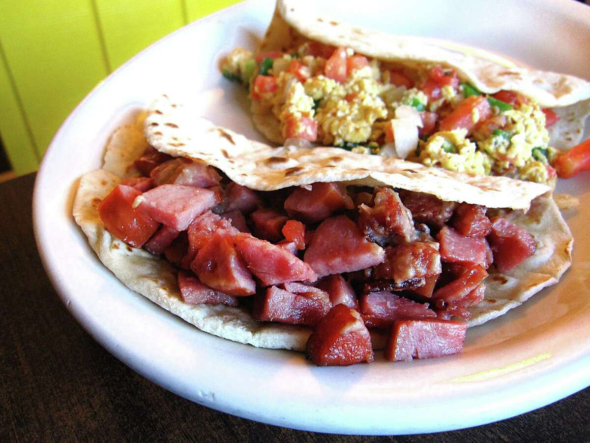 Country sausage and bean taco, foreground, and an eggs a la mexicana taco, both on handmade flour tortillas from Benjamin's Kitchen.