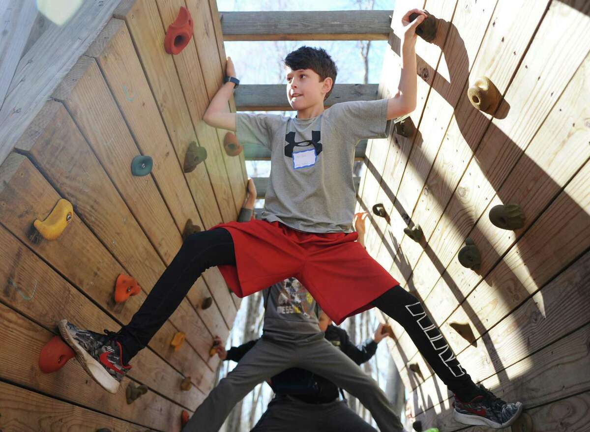 North Street School fifth-grader PJ Tone climbs the bouldering wall at Greenwich Public Schools' Orienteering Adventure Days at the Camp Seton Scout Reservation in Greenwich, Conn. Tuesday, April 18, 2017. Led by P.E. teachers and staff from Camp Seton Scout Reservation, all fifth graders from the eleven Greenwich Public Elementary Schools met and interacted with those students who will be in their sixth grade classes next year while participating in a variety of activities blending fitness, writing, map reading, and team building skills.