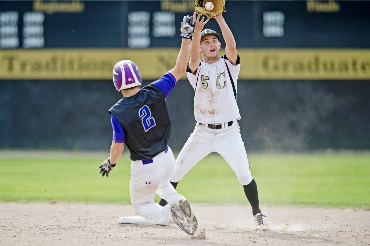 Bullock Creek's Brandon Bruman catches the ball as Swan Valley's John Espinosa gets ready to slide into second on Tuesday at Bullock Creek High School.