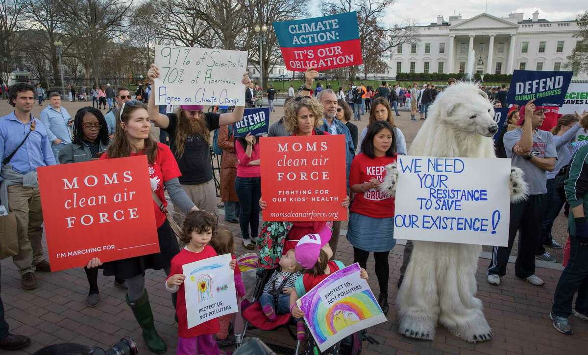 Demonstrators gather in front of the White House to voice their opposition after President Donald Trump signed an executive order that rolled back many climate-change policies, in Washington, March 28, 2017. In April, scientists and science advocates are expected to fill the streets for the March for Science, a rally in support of scientific research, which many feel has increasingly come under attack during the Trump administration.
