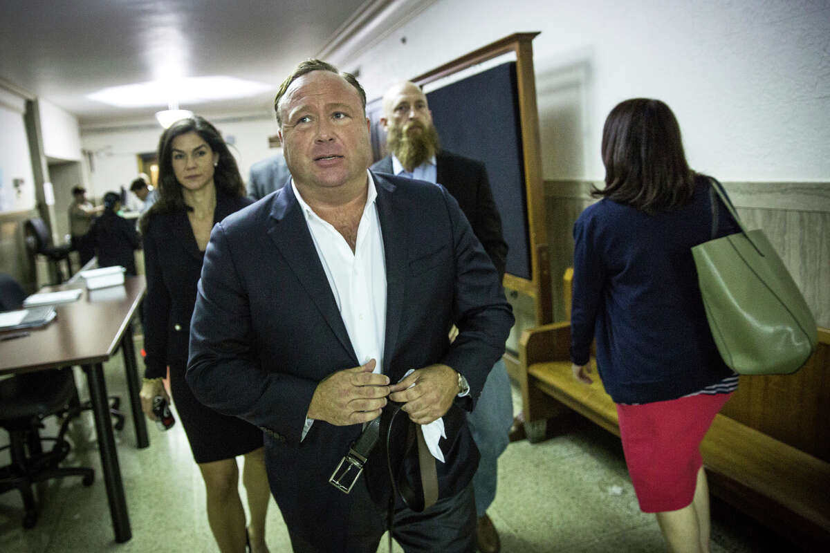In this Monday, April 17, 2017 photo, "Infowars" host Alex Jones arrives at the Travis County Courthouse in Austin, Texas. Jones, the right-wing radio host and conspiracy theorist, is a performance artist whose true personality is nothing like his on-air persona, according to a lawyer defending the "Infowars" broadcaster in a child custody battle. (Tamir Kalifa/Austin American-Statesman via AP)