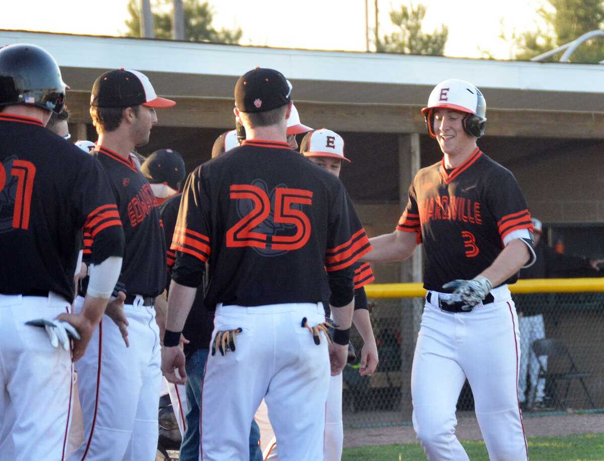 Edwardsville’s Jack Cooper, right, is greeted at home plate by his teammates after a walk-off homer in the eighth.