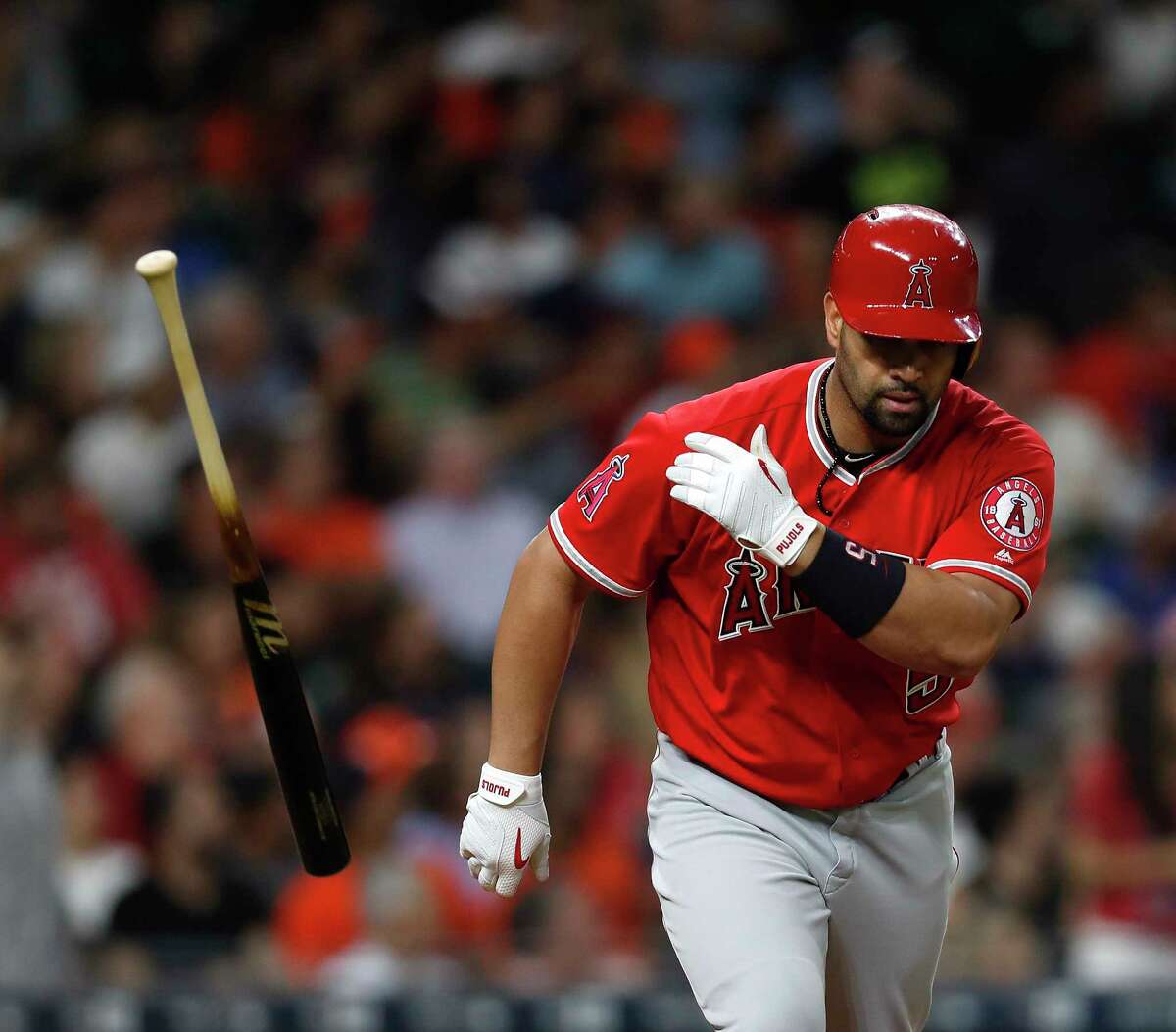 Los Angeles Angels designated hitter Albert Pujols (5) tosses his bat after hitting a three-run home run of of Astros starting pitcher Joe Musgrove during the fifth inning of an MLB baseball game at Minute Maid Park, Tuesday, April 18, 2017, in Houston.