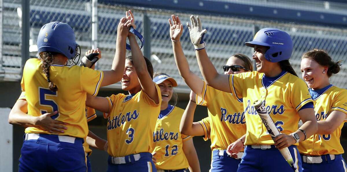 St. Mary’s Rattlers, including Kristal Salinas (3) and Raynelle Nash (5), celebrate after Marcela Vasquez knocked in the winning run against Rogers State.